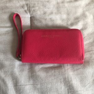 Adrienne Vittadina Pink wallet with zipper closure.
